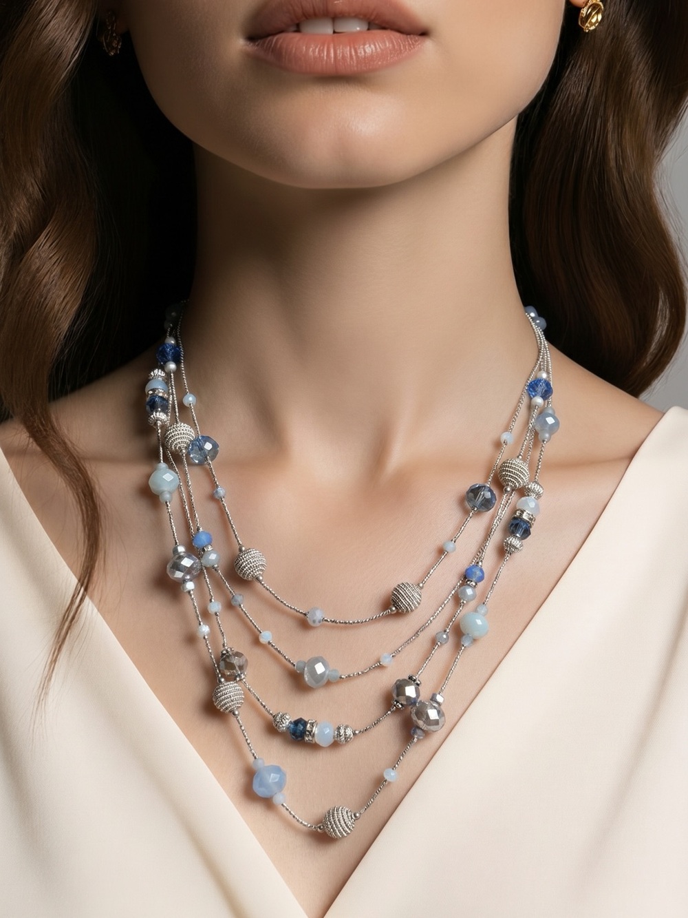 Silver-tone multi-strand beaded necklace featuring blue and gray beads.